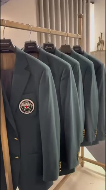 Row of tailored blazers finished and hanging on a rail in the shop